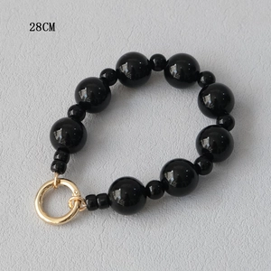 Detail of 28CM black acrylic beaded strap with polished gold-toned metal spring ring clasp