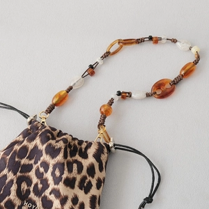 Leopard print drawstring bag featuring amber resin beaded chain and gold hardware