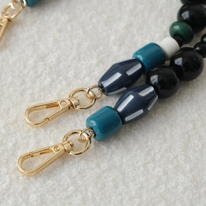 Close-up of stylish acrylic bead chain with a durable golden lobster metal clasp