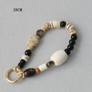 Detail view of 28cm mixed acrylic bead strap with golden metal spring clasp for bags