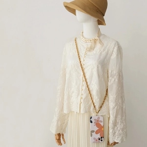 Detail of crossbody gold metal chain strap on floral phone case for stylish accessorizing