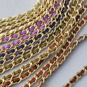 Detail of woven metal bag chains with colorful suede leather straps in various colors