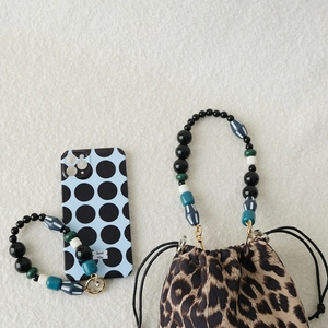 Acrylic bead handbag strap with gold metal buckle on a leopard print pouch
