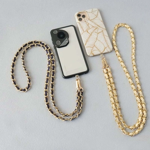 Detailed view of luxury crossbody phone chains with gold metal lobster clasps and leather