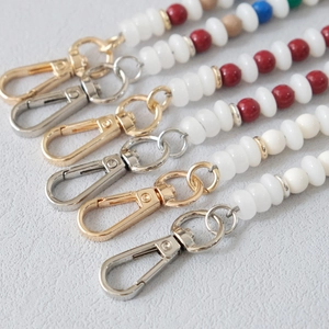 Detailed view of acrylic bead chains with colorful accents and metallic lobster clasps