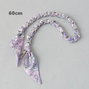 Close-up of a 60cm silver chain strap interwoven with purple floral silk scarf detail