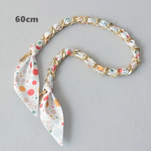 Close-up of 60cm gold chain strap interwoven with colorful polka dot silk scarf