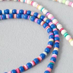Detail of colorful handmade acrylic beads with vibrant bohemian heishi clay spacers