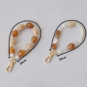 Detail of 28cm apricot acrylic bead chains with gold lobster clasps for bags and phones
