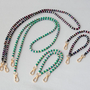 Detail of colorful acrylic bead straps with high-quality gold lobster clasps and clay beads
