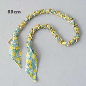 Detail showing a 60cm golden metal chain interwoven with lemon pattern fabric strap
