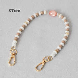 Detail of 37cm beaded chain with acrylic pearls, pink gemstone, and gold lobster clasps