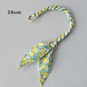 Detail of 26cm woven bag handle with yellow lemon print scarf and gold metal rings
