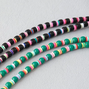 Close-up of colorful acrylic and heishi clay beads for DIY fashion jewelry chains