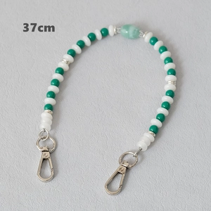 Detail view of 37cm acrylic beaded chain with green and white pearls and silver lobster clasps