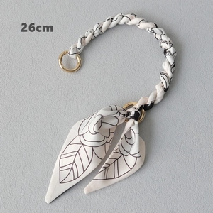 Detail of 26cm floral woven handbag strap with elegant gold metal ring buckles