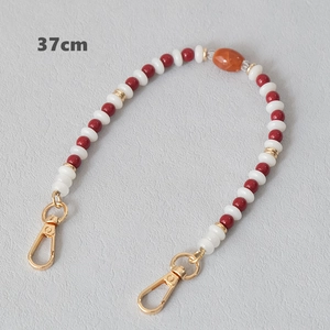 Detailed view of a 37cm candy-colored acrylic beaded chain with gold lobster clasps