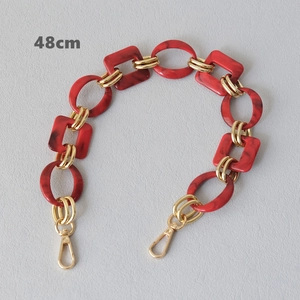 Detail view of 48cm red marble resin chain with gold metal lobster clasps for handbags