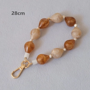 Detail of 28cm acrylic bead chain with amber marble water drop beads and golden clip