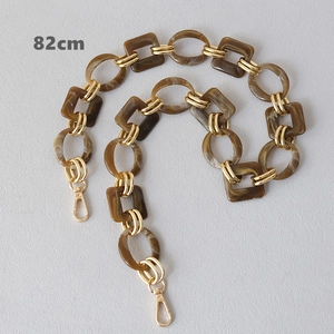 Detailed 82cm handbag strap with amber resin links and gold metal lobster clasps