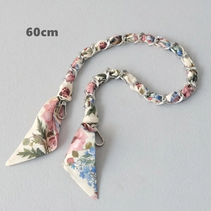 Detail of 60cm silver chain strap with floral silk ribbon and metal lobster clasps