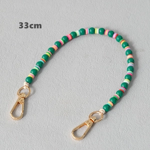 Detailed view of a 33cm acrylic and clay bead strap with gold lobster clasps