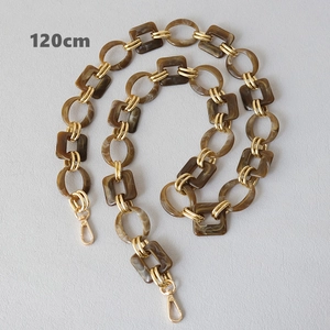 Detail of 120cm amber resin and gold metal chain strap for fashion handbags