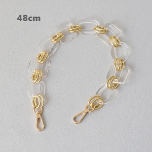 Detail of 48cm acrylic and gold metal chain strap accessory with lobster clasps