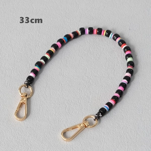 Detailed view of a 33cm colorful clay bead chain with golden metal lobster clasps