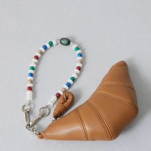 Brown croissant coin purse with colorful beaded wrist strap and silver lobster clasp