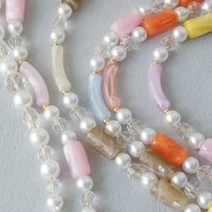 Macro detail of colorful acrylic beads and pearls for jewelry chains and straps