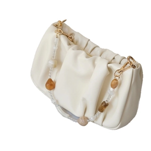 Chic beige ruched cloud bag with amber and white acrylic beaded strap and gold hardware