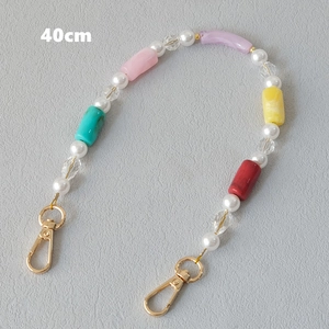 Detail view of 40cm colorful acrylic beaded chain with gold lobster clasps and pearls