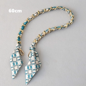 Détail de la bandoulière 60cm en chaîne dorée entrelacée de ruban bleu et foulards