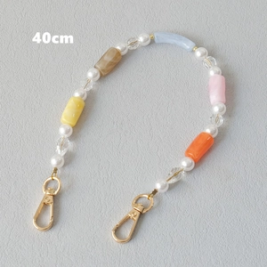 Detail of 40cm colorful acrylic beaded strap with gold lobster clasps and pearls