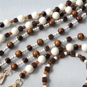 Detail of beaded bag strap with acrylic and wooden beads and golden lobster clasp