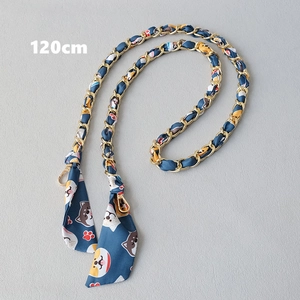Detail of 120cm golden metal chain interwoven with dark blue Shiba Inu print silk ribbon