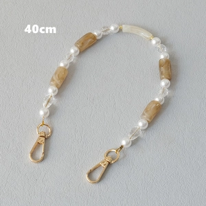 Detail of 40cm acrylic bead strap with pearls and amber resin tubes for bags