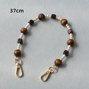 Detail of 37cm vintage handmade wooden bead chain with golden metal lobster clasps
