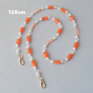 Detail of 120cm acrylic and pearl crossbody strap with gold metal lobster clasps
