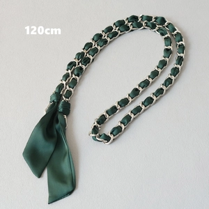 Detail view of 120cm dark green satin silk ribbon woven through a silver metal handbag chain