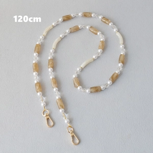 Detail of 120cm acrylic and pearl strap with amber beads and golden metal lobster clasps