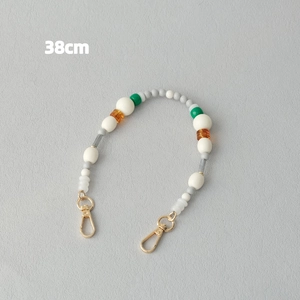 Détail de la sangle en perles acryliques de 38cm aux couleurs bonbon et fermoirs dorés