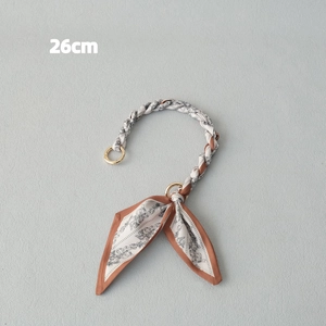 Detail of 26cm scarf chain bag strap in caramel satin fabric with gold metal rings