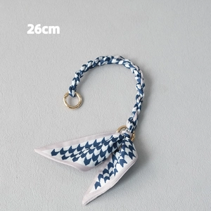26cm handbag strap detail featuring blue and white checkered weave with a bow and gold clasp