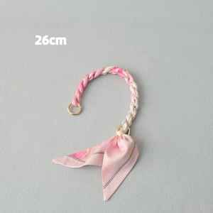 Detail of 26cm pink and white woven satin scarf handle with gold rings and ribbons