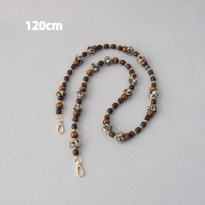 Detail of 120cm leopard print plush and wood bead crossbody chain with gold clasps