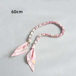 Détail d'une bandoulière de 60cm en foulard de soie rose entrelacé d'une chaîne argentée
