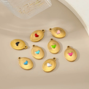Close-up of eight colorful enamel heart pendants with gold plated sunburst texture