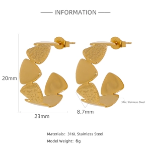 Macro detail of gold 316L stainless steel C-shape earrings with geometric triangle layers